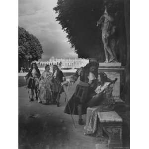  Costumed People Wandering Around the Gardens of Versailles 
